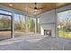 Enclosed sunroom with stone flooring, fireplace, wood ceiling, and views of the backyard at 1318 Ivy Ln, Raleigh, NC 27609