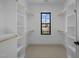 Spacious walk-in closet with custom shelves and a window for natural light at 1318 Ivy Ln, Raleigh, NC 27609