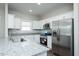 Modern kitchen with white cabinetry, stainless steel appliances, and a granite island at 133 Ambergate Ct, Rocky Mount, NC 27804