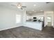 Open-concept living area with hardwood floors and modern finishes leading into the kitchen at 133 Ambergate Ct, Rocky Mount, NC 27804