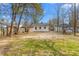 Large backyard featuring grassy areas, a wooden fence, and access to other homes at 1409 Ida St, Durham, NC 27705