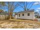 Home backyard featuring well kept vinyl siding, a storage shed, and room for activities at 1409 Ida St, Durham, NC 27705