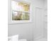 Bright bathroom featuring a white shower and a window with a view of the trees at 1409 Ida St, Durham, NC 27705