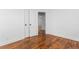Bedroom featuring freshly painted walls, closet doors and refinished hardwood floors at 1409 Ida St, Durham, NC 27705