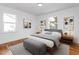 Bright bedroom with hardwood floors, neutral bedding, and ample natural light at 1409 Ida St, Durham, NC 27705