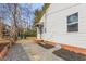 Exterior side view featuring well kept vinyl siding, a doorway, and new gravel at 1409 Ida St, Durham, NC 27705
