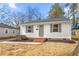 Well-maintained home featuring gray shutters, new landscaping and a freshly painted exterior at 1409 Ida St, Durham, NC 27705