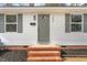 Charming home featuring a new front door, brick stairs, and shutters at 1409 Ida St, Durham, NC 27705