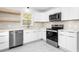 Modern kitchen featuring white cabinets, stainless steel appliances, and plenty of counter space at 1409 Ida St, Durham, NC 27705
