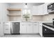 Stylish kitchen with white cabinetry, stainless appliances, and modern finishes at 1409 Ida St, Durham, NC 27705