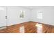 Bright living room featuring natural light, fresh paint, and newly refinished hardwood floors at 1409 Ida St, Durham, NC 27705