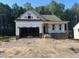 Under construction, this new home displays brick accents and a two-car garage ready to be completed with your personal touch at 151 Tigris Ct, Zebulon, NC 27597
