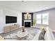 Bright living room with neutral paint, a fireplace, and large windows for plenty of natural light at 151 Tigris Ct, Zebulon, NC 27597