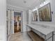 Bathroom featuring double vanity sinks, tile flooring, shower, and walk-in closet at 1535 Caraleigh Mills Ct # 105, Raleigh, NC 27603