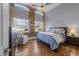 Bedroom featuring exposed brick wall with large windows, wood flooring, and vaulted ceilings at 1535 Caraleigh Mills Ct # 105, Raleigh, NC 27603