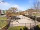 Community dog park featuring fenced areas, trees, and play structures at 1535 Caraleigh Mills Ct # 105, Raleigh, NC 27603