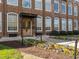 Charming brick building featuring arched windows and a welcoming entrance with colorful flower beds at 1535 Caraleigh Mills Ct # 105, Raleigh, NC 27603