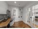 Bright office area with wood flooring, built-in shelves, desk, with French doors to kitchen at 1535 Caraleigh Mills Ct # 105, Raleigh, NC 27603