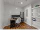 Bright office space with wood flooring, built-in shelves, desk, and dual monitors at 1535 Caraleigh Mills Ct # 105, Raleigh, NC 27603