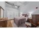 Bedroom with dual closets, ceiling fan and hardwood floors at 1535 Caraleigh Mills Ct # 105, Raleigh, NC 27603