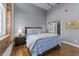 Bright bedroom with hardwood floors, ensuite bathroom and exposed brick wall at 1535 Caraleigh Mills Ct # 105, Raleigh, NC 27603