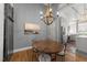 Charming dining room with hardwood floors, chandelier, and view into the kitchen at 1535 Caraleigh Mills Ct # 105, Raleigh, NC 27603