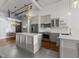 Modern kitchen with stainless steel appliances, island, and unique flooring at 1535 Caraleigh Mills Ct # 105, Raleigh, NC 27603