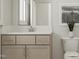 Bathroom featuring a gray vanity with ample counter space and neutral decor at 1569 Goldfinch Perch Ln, Knightdale, NC 27545