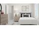 A neutral bedroom design with wood dresser and night stand, and window views at 1569 Goldfinch Perch Ln, Knightdale, NC 27545