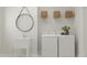 Well-lit laundry room with a utility sink, washer and dryer, and storage baskets at 1569 Goldfinch Perch Ln, Knightdale, NC 27545