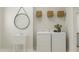Bright laundry room with a utility sink, washer and dryer, and woven baskets at 1569 Goldfinch Perch Ln, Knightdale, NC 27545