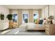 Bright bedroom featuring three windows, a stylish chair, and modern furnishings at 1573 Goldfinch Perch Ln, Knightdale, NC 27545