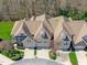 A beautiful aerial view of townhomes with brick and siding exteriors and private garages at 162 Arabella Ct, Cary, NC 27518
