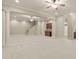 Expansive finished basement area with wet bar, columns, neutral paint, carpet, and staircase at 162 Arabella Ct, Cary, NC 27518
