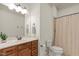 Bright bathroom features a wooden vanity, large mirror and combination shower and bathtub at 162 Arabella Ct, Cary, NC 27518