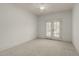 Bright bedroom with ceiling fan and double doors leading to a balcony at 162 Arabella Ct, Cary, NC 27518