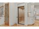 Interior elevator with wood paneling and flooring adjacent to the stairs and kitchen at 162 Arabella Ct, Cary, NC 27518