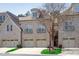 Elegant townhome featuring a brick facade, multiple garage bays, and Juliet balconies on the second floor at 162 Arabella Ct, Cary, NC 27518
