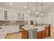 Stylish kitchen with white cabinetry, granite countertops, and modern stainless steel appliances at 162 Arabella Ct, Cary, NC 27518
