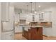 Beautiful kitchen with white cabinets, granite countertops, and a farmhouse sink at 162 Arabella Ct, Cary, NC 27518
