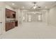 Expansive living room featuring columns, bar with cabinets, and multiple ceiling fans at 162 Arabella Ct, Cary, NC 27518