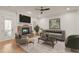 Comfortable living room with a stone fireplace, modern decor, and plenty of natural light at 162 Arabella Ct, Cary, NC 27518