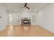 Bright living room with hardwood floors, a stone fireplace, and seamless access to outdoor spaces at 162 Arabella Ct, Cary, NC 27518