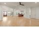 Open-concept living space featuring hardwood floors, white pillars, and a seamless flow to the kitchen and stairs at 162 Arabella Ct, Cary, NC 27518