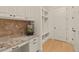 Mudroom featuring custom cabinets, granite countertops, and built-in cubbies near a door at 162 Arabella Ct, Cary, NC 27518