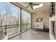 Screened porch featuring an outdoor ceiling fan, and brick accent wall with stylish clock art at 162 Arabella Ct, Cary, NC 27518