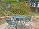 Cozy backyard with a metal table and chairs set amidst lush greenery at 1628 Park Dr, Raleigh, NC 27605