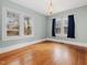 Bright bedroom with hardwood floors, large windows, and an overhead light fixture at 1628 Park Dr, Raleigh, NC 27605