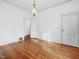 Spacious bedroom with hardwood floors, an overhead light fixture, and two doors at 1628 Park Dr, Raleigh, NC 27605