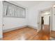 Bedroom features pristine white walls and original hardwood floors at 1628 Park Dr, Raleigh, NC 27605